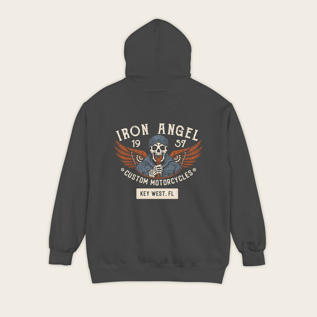 Flat lay back view of the Iron Angel Custom Motorcycles Comfort Colors 1567 heavyweight 9.5 oz fleece pullover hoodie in Pepper Black featuring skeleton wrench-bearer with mechanical wings built from gears and chain, and 1957 Key West custom garage crest.
